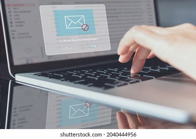 Blocking spam e-mail, warning pop-up for phishing mail, network security concept. Business woman working on laptop computer at home with warning window on screen