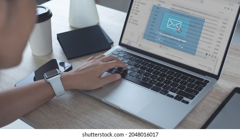 Blocking spam e-mail, warning pop-up for phishing mail, network security concept. Business woman working on laptop computer at home with warning window on screen - Shutterstock ID 2048016017