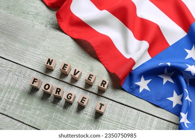 Blocks with inscription in memory of  National Day of Prayer and Remembrance for the Victims of the Terrorist Attacks on light wooden background