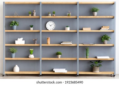 Blog about interiors, stylish design, Scandinavian style and decor elements at home. Gray wall, shelf with books, accessories, clock and potted plants in cozy living room, flat lay, free space
