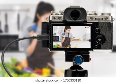 Blogger Asian Women Are Beginning A Home-based Business To Online Teach Cooking. Camera Live Streaming Woman Holding Smartphone And Credit Card In Monitor. Work From Home.