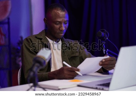 Blogger checking script he wrote for podcast or blog Stock photo © 