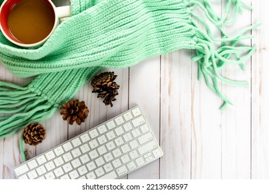 Blogger Fall Cozy Sweater Weather Autumn Arrangement, With White Keyboard, Pine Cones, Cable Knit Teal Scarf And Coffee Mug On Wood Background