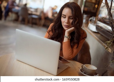 Blogger freelancer woman using laptop PC blogging in wifi connected internet in cafe