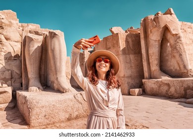 A Blogger Girl Takes A Selfie Against The Ruins Of The Grandiose Karnak Temple In The Ancient City Of Luxor In Egypt