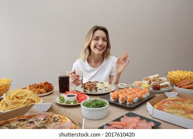 Blogger With Lots Of Food At Table Against Beige Background. Mukbang Vlog