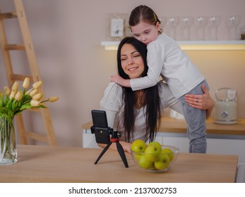 Blogger Mom With Her Baby At Home. Millennial Influencer Woman Creating Content For Her Motherhood Blog, Recording Streaming Online Stories For Social Network, Writing Blog To Video Platform