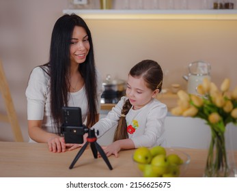 Blogger Mom With Her Baby At Home. Millennial Influencer Woman Creating Content For Her Motherhood Blog, Recording Streaming Online Stories For Social Network, Writing Blog To Video Platform