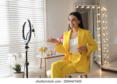 Blogger recording video in dressing room at home. Using ring lamp and smartphone - Powered by Shutterstock