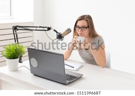 Blogger, streamer and people concept - Funny young woman DJ working on the radio