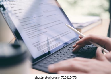 Blogger using mobile touchpad for work.Closeup view of male hands typing electronic tablet keyboard-dock station.Horizontal, blurred background - Powered by Shutterstock