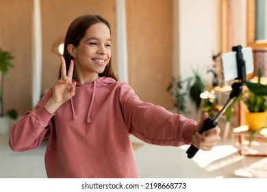 Blogging Concept. Happy Teen Girl Recording Lifestyle Blog Talking To Cellphone Webcamera On Tripod, Young Influencer Filming Vlog For Her Channel