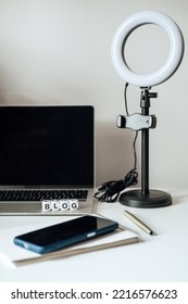 Blogging Equipment. How To Start Blog, Blogging For Beginners. Laptop, Mobile Phone, Ring Light, Notebook And Glasses On The Table