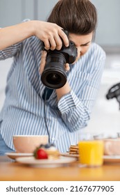 blogging, profession and people concept - female food photographer with camera photographing pancakes, coffee and orange juice in kitchen at home - Shutterstock ID 2167677905
