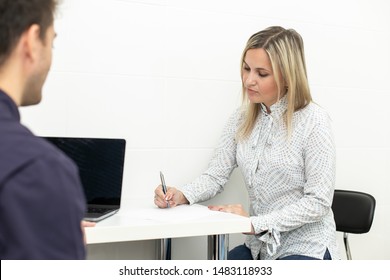 Blond Adult Woman Signing Up Contract In Hospital On Buisness Meeting. Selective Focus