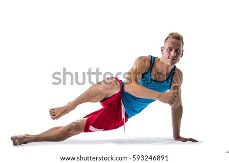 Blond athletic young man exercizing on the floor, isolated on white background in studio shot