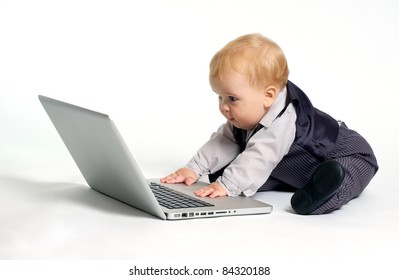 blond baby working with laptop