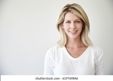 Blond and blue eyed beautiful woman smiling to camera