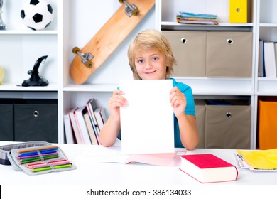 Blond Boy On Desk With Good Report Card