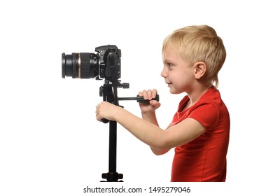 Blond Boy Shoots Video On DSLR Camera. Side View. White Background, Isolate