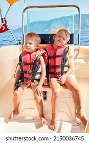 Blond Brothers In Life Jackets Feel Bored Sailing In Sea At Boat Trip In Marmaris. Toddler And Preschooler Boys On Summer Vacation In Turkey