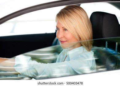 Blond Business Woman Driving Car