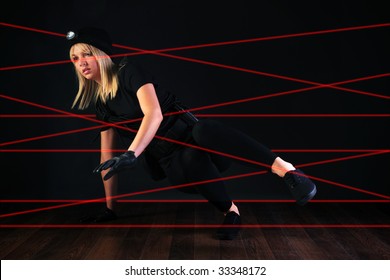 Blond Cat Burglar Climbing Through A Laser Beam Alarm System.