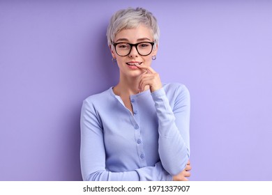 Blond Caucasian Woman With Short Hair Teasing With Finger On Mouth Isolated On Purple