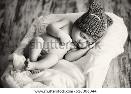 Similar – Newborn baby girl sleeping lying on bed next to mother’s hand