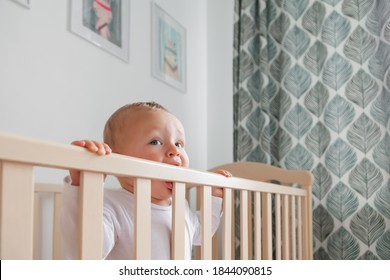 Blond Cute Little Baby Biting Wooden Bed Headboard