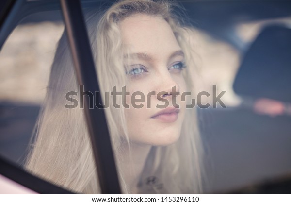 Blond girl behind the window
