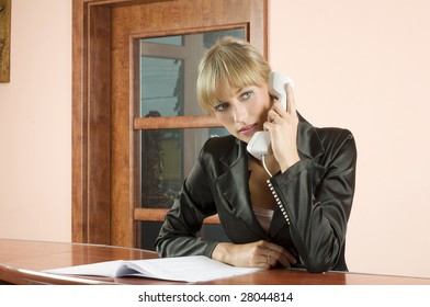 Blond Girl In Hotel Reception Talking At Telephone