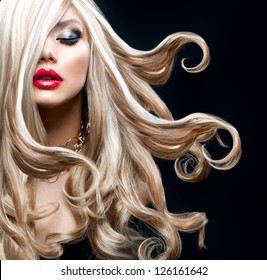 Blond Hair. Beautiful Sexy Blonde Girl. Beauty isolated on a Black Background