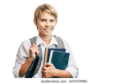 Blond happy schoolboy carrying books and schoolbag