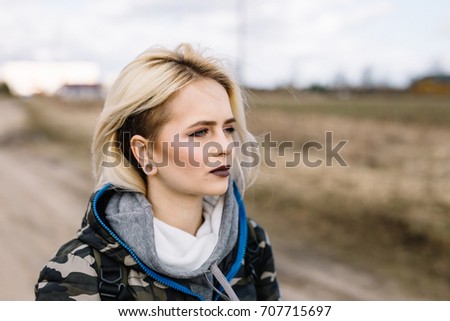Blond hipster girl in army style.