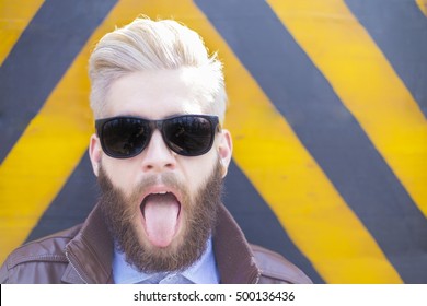 Blond Hipster Guy With Beard Sticking His Tongue Out.