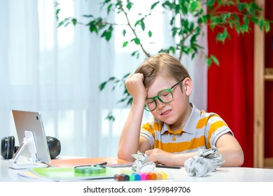 Blond Kid With Freckles Sitting At The Table Surprised With Hand On Head For Mistake, Remember Error. Pupil Forgot. Bad Memory Concept. Stressed And Tired Boy With Laptop Has Online Lesson At School