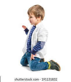 Blond Kid Sit On The Floor Over White Background