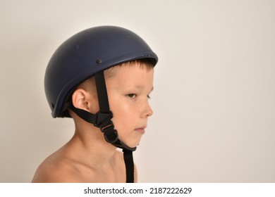 A Blond Man In A Blue Motorcycle Helmet Is Turned Sideways To The Camera.