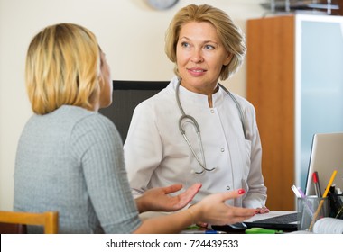 Blond patient and senior therapeutist at appointment in clinic