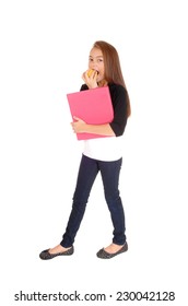 A Blond Pretty Eight Year Old Girl Standing For White Background, Holding Her Folder, Eating An Apple. 