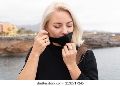 Blond Relaxed Girl Breathing And Calming Down, Taking Off Mask, Looking Into The Future Concept, Mask And Pandemia Free