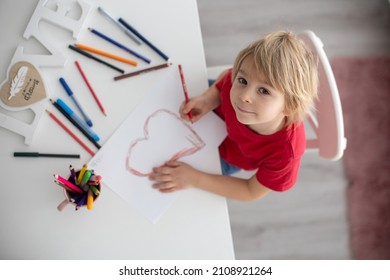 Blond toddler child  drawing picture and heart for valentine  gift for mom  gift for mom for Mothers day