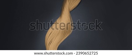 Blond wavy hair on black background. Hairdresser service, hair strength, haircut, hairstyle. Concept hairdresser spa salon