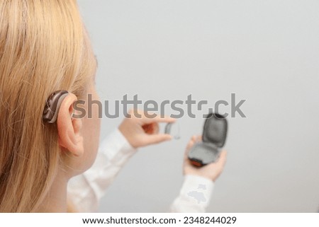 Similar – Image, Stock Photo Woman applying hearing aid to ear