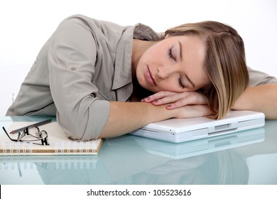 Blond woman asleep on laptop