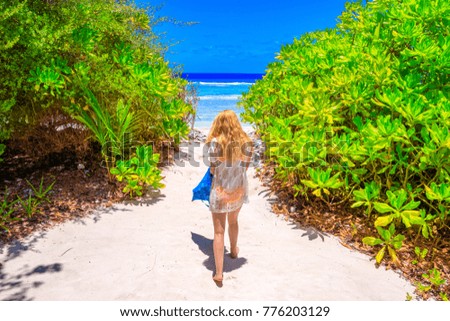 Blond woman with bikini at the sea on Maldives