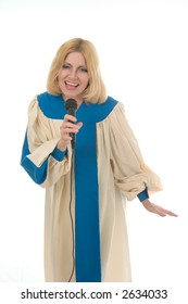 Blond Woman In A Choir Robe Holding A Microphone And Singing.