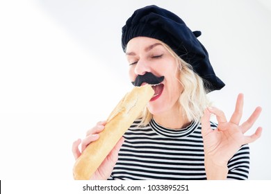 Blond Woman Dressed As A French Man With Beard And Beret Eating Baguette