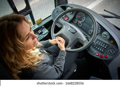 Blond woman driving a bus